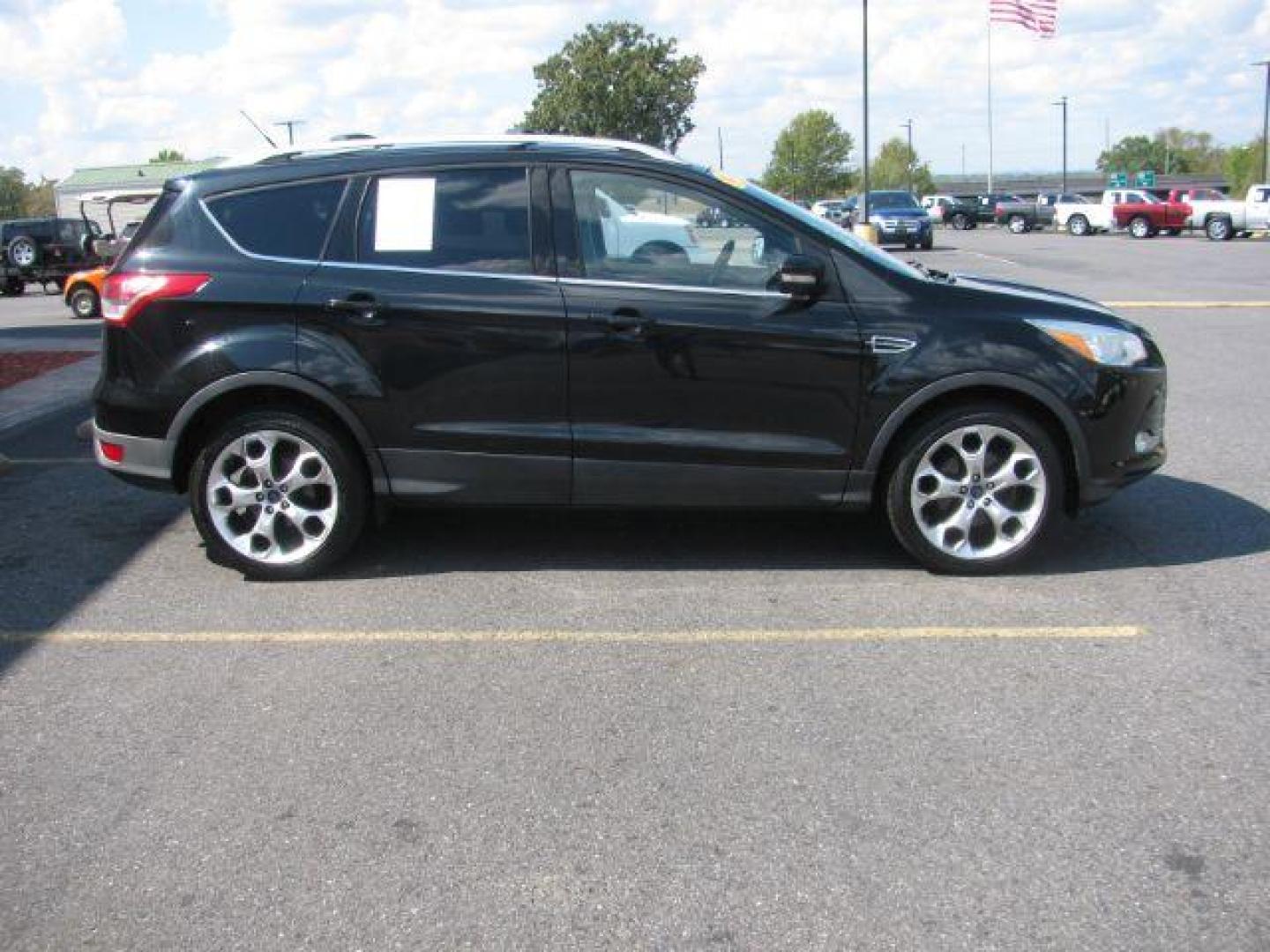 2014 Black Ford Escape Titanium FWD (1FMCU0JX0EU) with an 1.6L L4 DOHC 16V engine, 6-Speed Automatic transmission, located at 2443 Albert Pike, Hot Springs, AR, 71913, (501) 623-6255, 34.492222, -93.109993 - Photo#1