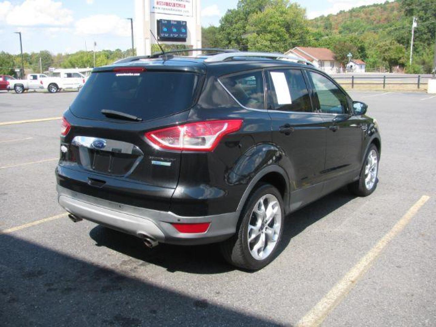 2014 Black Ford Escape Titanium FWD (1FMCU0JX0EU) with an 1.6L L4 DOHC 16V engine, 6-Speed Automatic transmission, located at 2443 Albert Pike, Hot Springs, AR, 71913, (501) 623-6255, 34.492222, -93.109993 - Photo#2