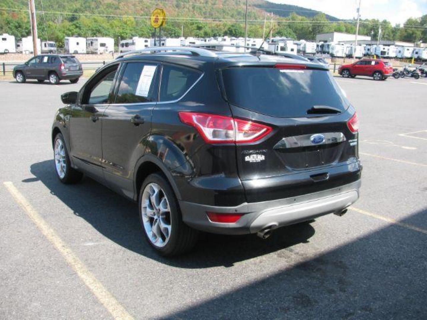 2014 Black Ford Escape Titanium FWD (1FMCU0JX0EU) with an 1.6L L4 DOHC 16V engine, 6-Speed Automatic transmission, located at 2443 Albert Pike, Hot Springs, AR, 71913, (501) 623-6255, 34.492222, -93.109993 - Photo#3