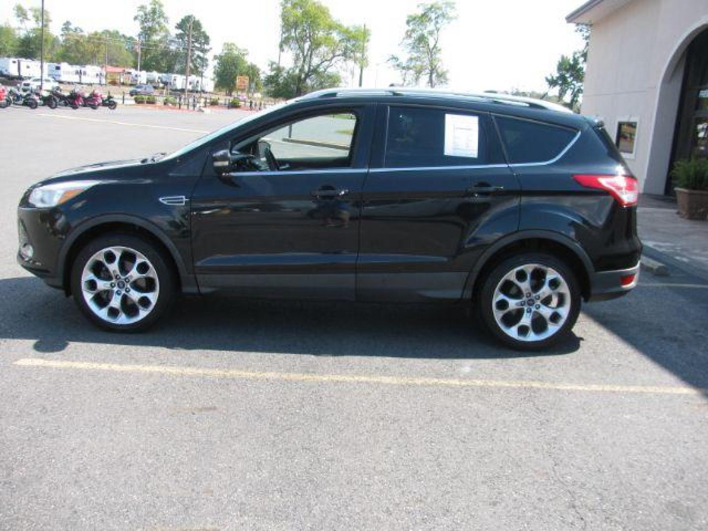 2014 Black Ford Escape Titanium FWD (1FMCU0JX0EU) with an 1.6L L4 DOHC 16V engine, 6-Speed Automatic transmission, located at 2443 Albert Pike, Hot Springs, AR, 71913, (501) 623-6255, 34.492222, -93.109993 - Photo#4